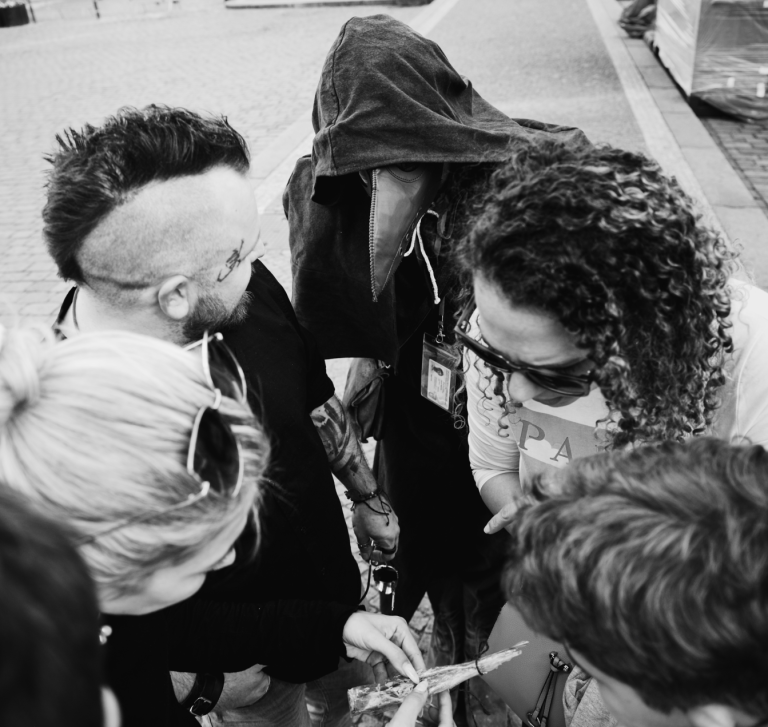 Private tour group is trying to solve the riddle with the Plague doctor checking.