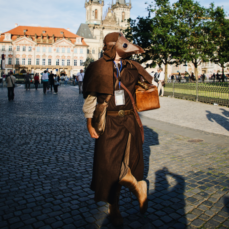 Plague doctor is posing on Old Town Square